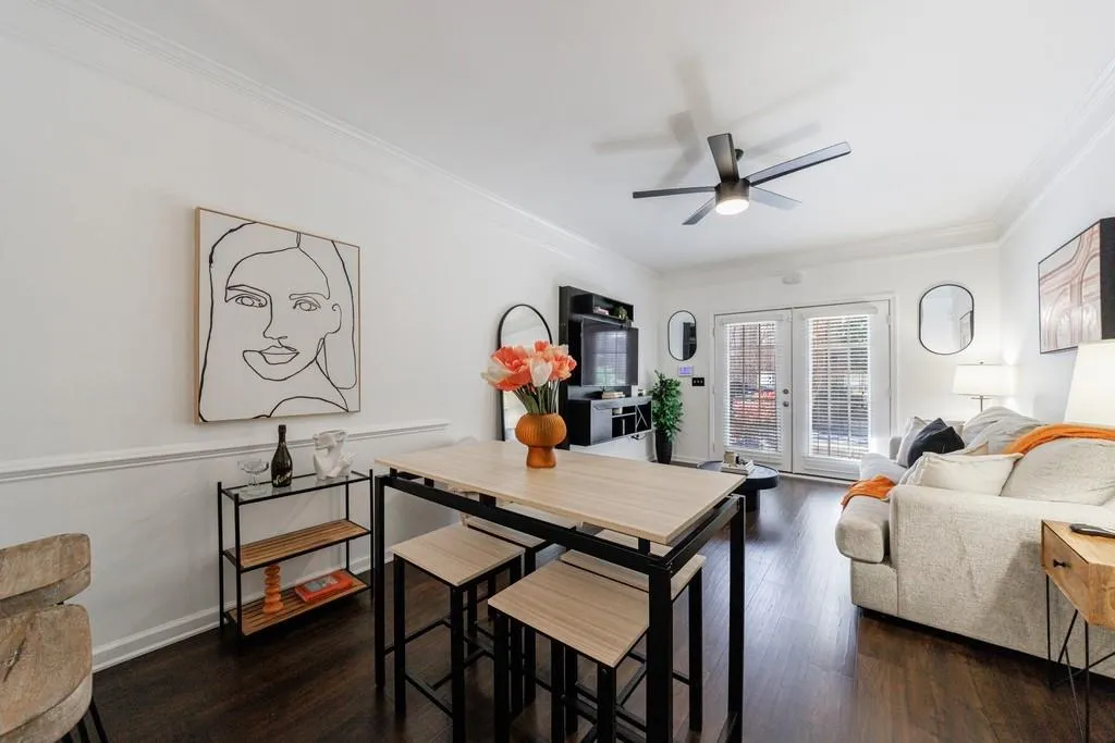 Dining space featuring ornamental molding, ceiling fan, dark hardwood / wood-style flooring, and french doors