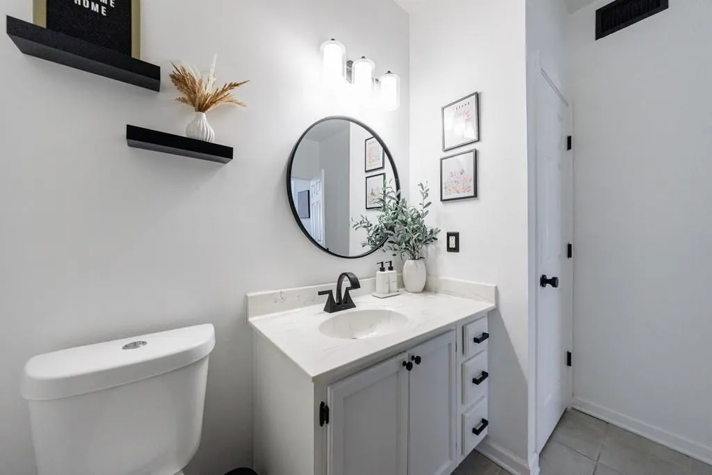 Bathroom with tile patterned flooring, vanity, and toilet