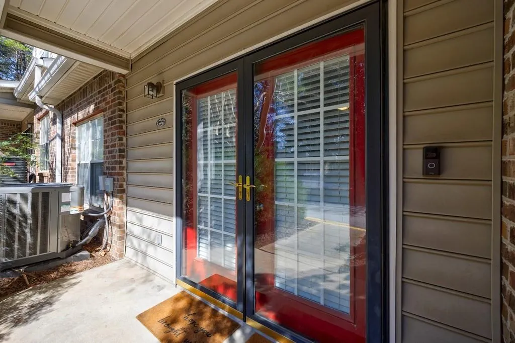 Doorway to property featuring central air condition unit