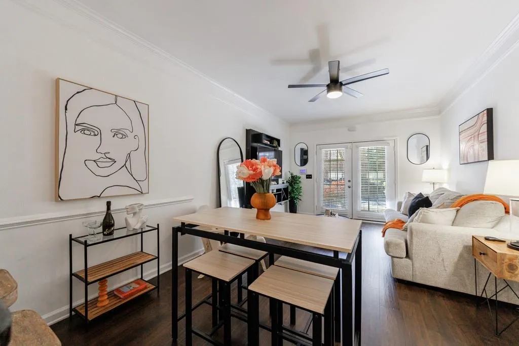 Dining space featuring french doors, ceiling fan, dark hardwood / wood-style flooring, and crown molding