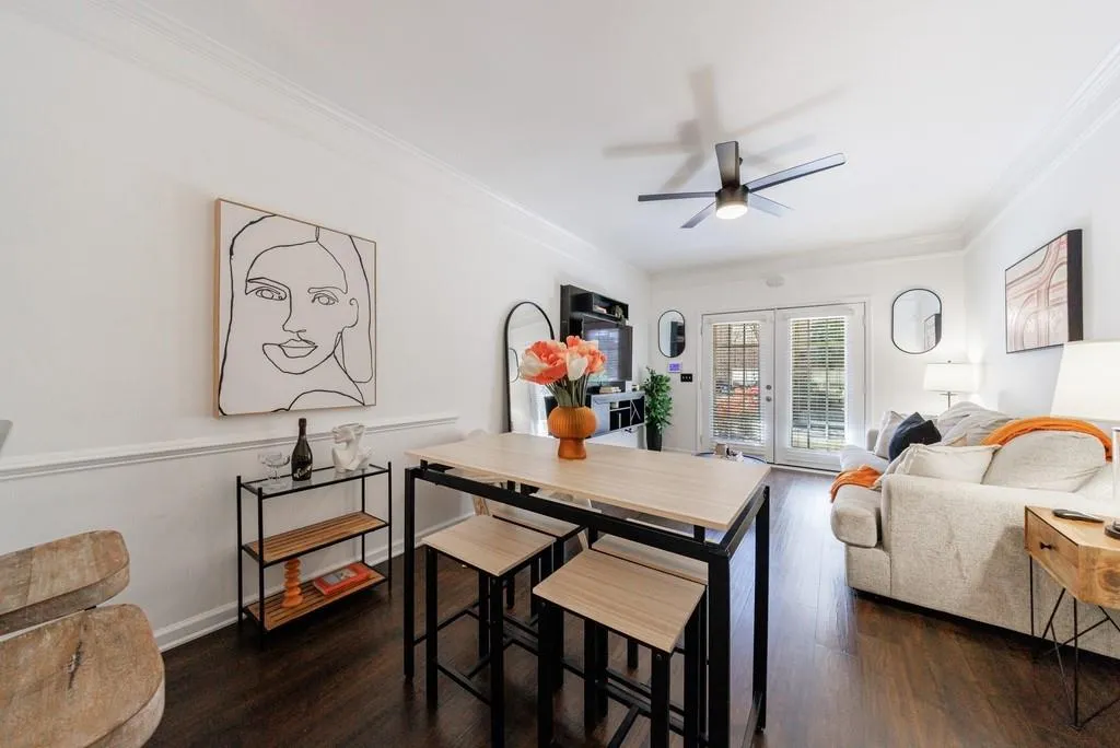 Dining space with dark hardwood / wood-style flooring, ornamental molding, french doors, and ceiling fan