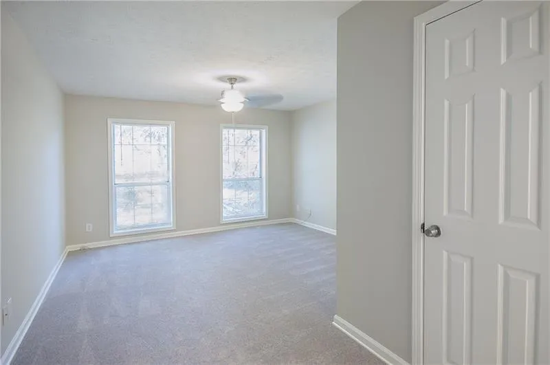 Empty room with carpet flooring and ceiling fan