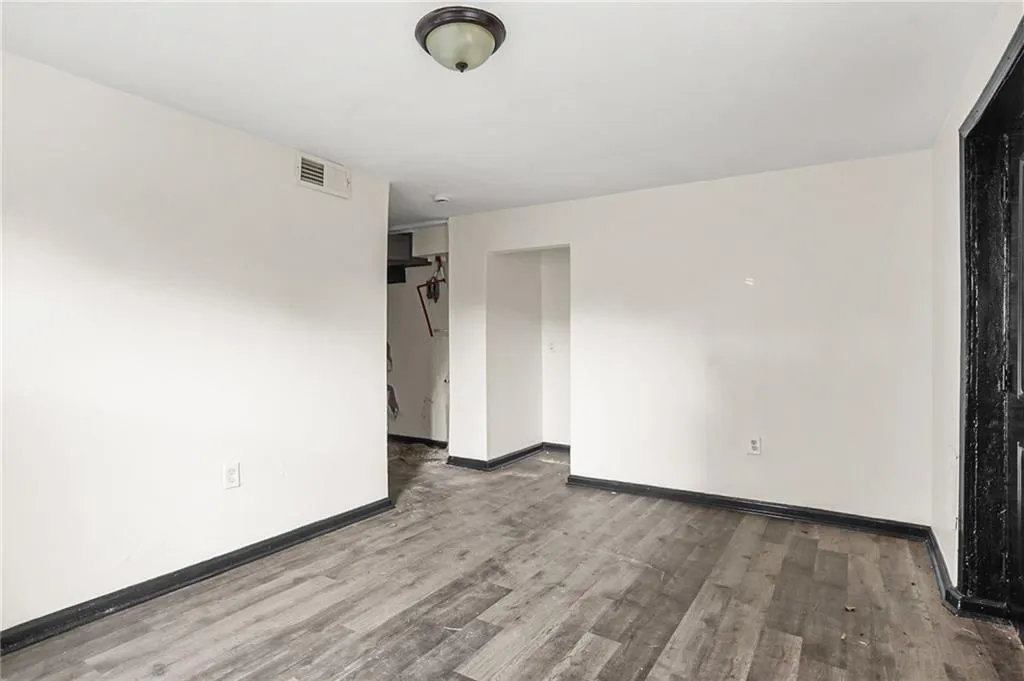 Spare room featuring wood finished floors and baseboards