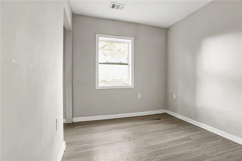 Unfurnished room featuring light wood-style floors and baseboards