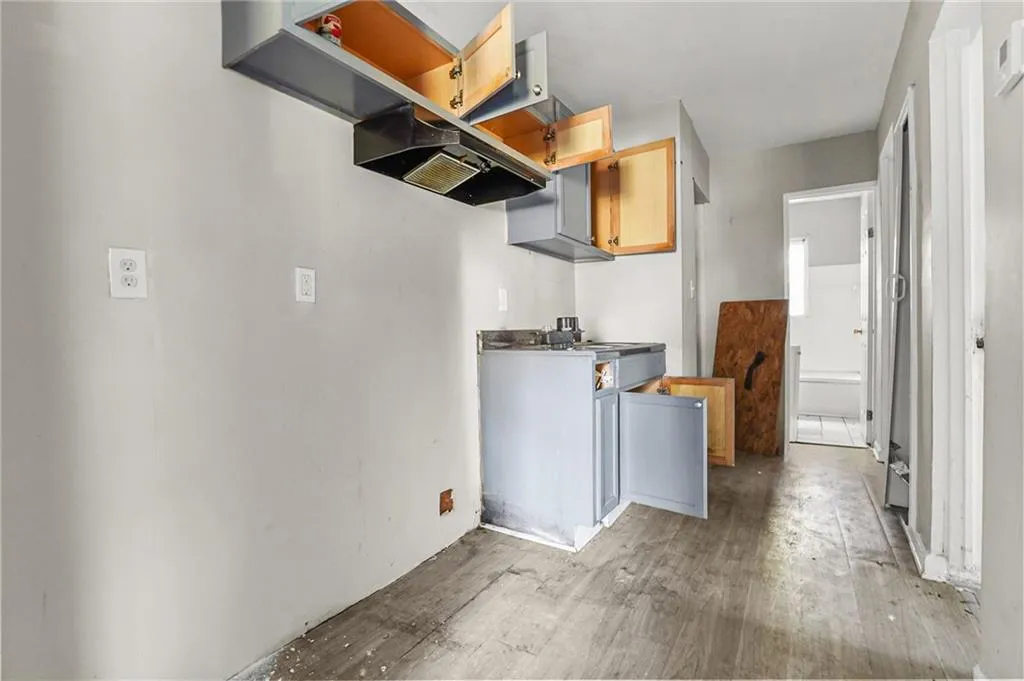 Kitchen featuring light wood-type flooring and range hood