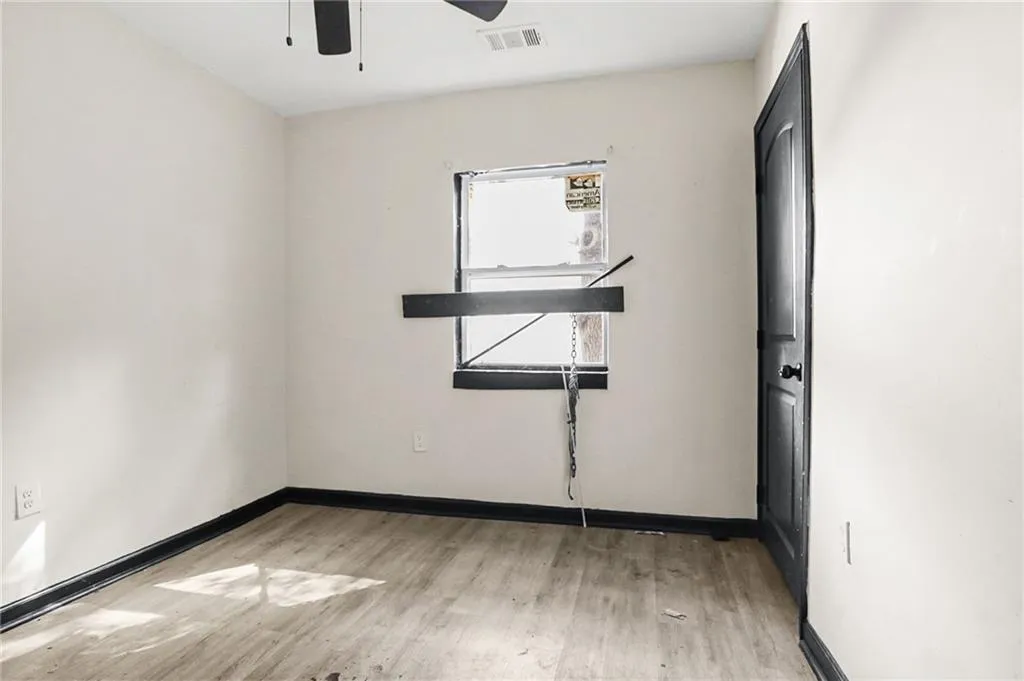 Unfurnished room with light wood-style floors and ceiling fan