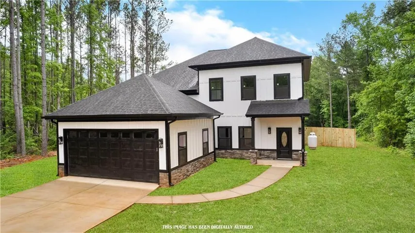 Modern exterior with white siding, black trim, a dark asphalt shingle roof, stone veneer accents, and an attached two-car garage