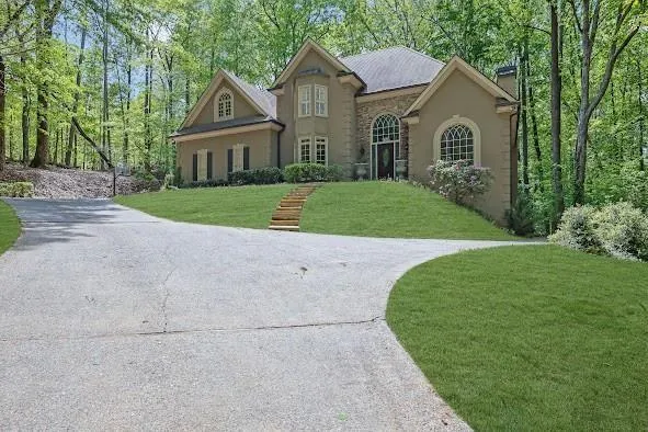 Stucco exterior with stone accents and arched windows