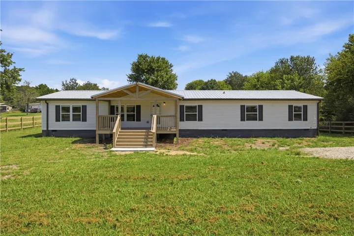White horizontal siding exterior with dark shutters