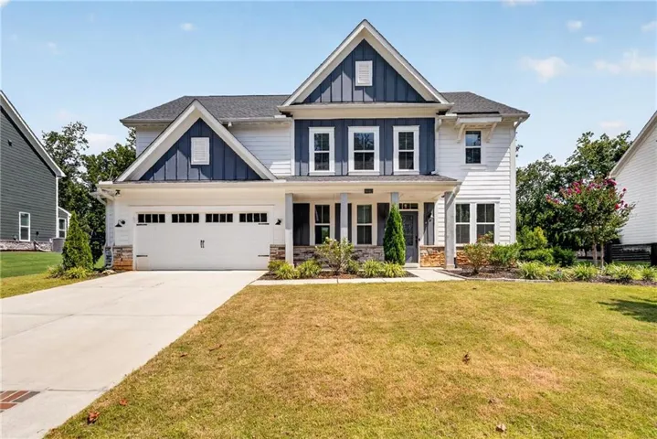 Contemporary two-story exterior with white siding and blue board and batten accents