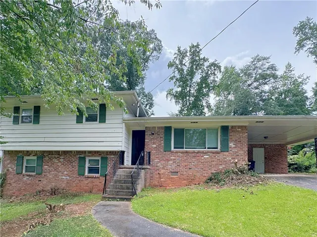 Brick and siding exterior with a covered carport