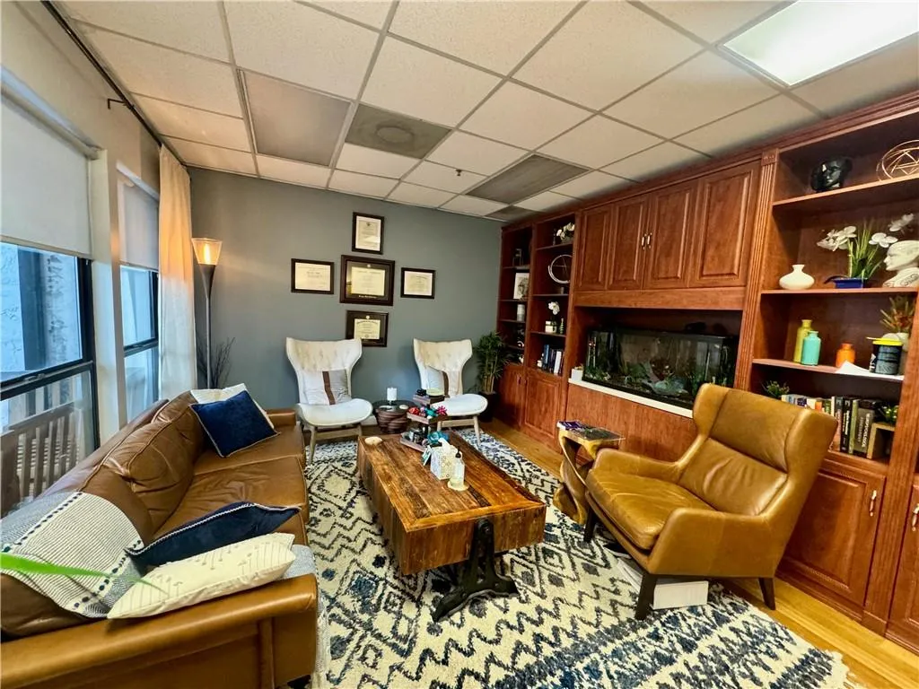 Featuring gorgeous views, hardwood flooring, built in cabinets, and a fish tank