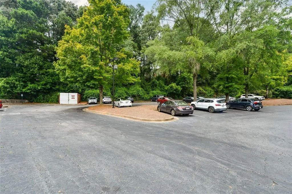 View of uncovered parking lot, with plenty of parking available