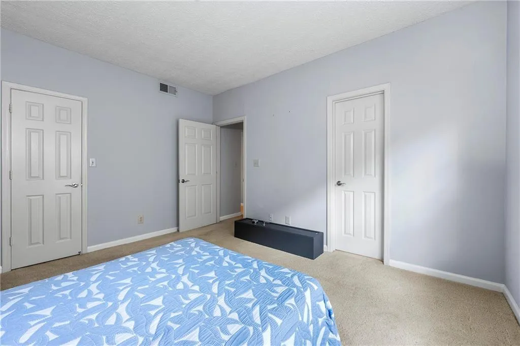 Bedroom featuring carpet floors and a textured ceiling