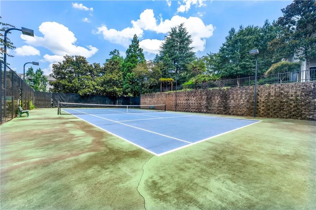 View of tennis court featuring community basketball court