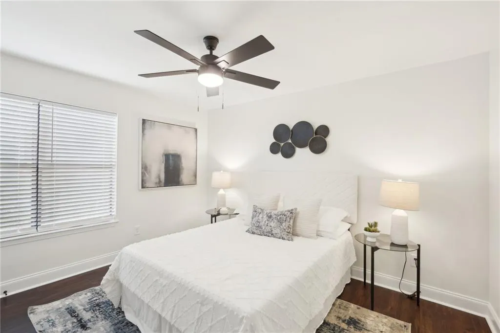 Bedroom with wood finished floors, ceiling fan, and baseboards