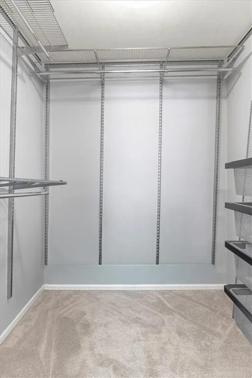 Walk in closet with custom shelving.