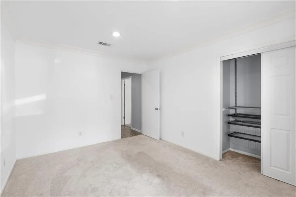 Unfurnished bedroom with custom closet, carpet, a closet, and recessed lighting