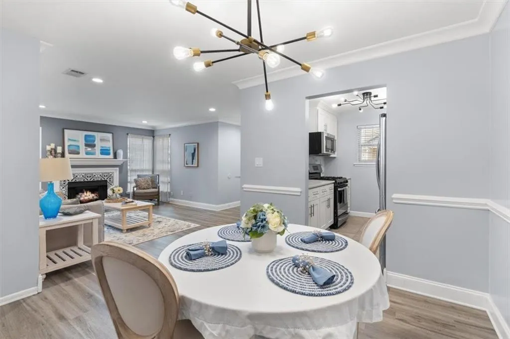 Dining area featuring, a chandelier, light wood finished floors, and ornamental molding