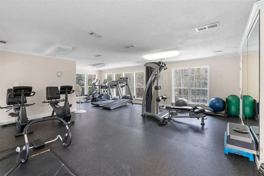 Gym featuring a textured ceiling