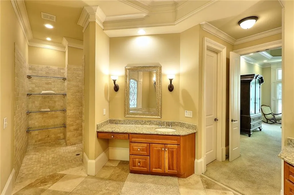 Bathroom with vanity, a tile shower, tile floors, and crown molding