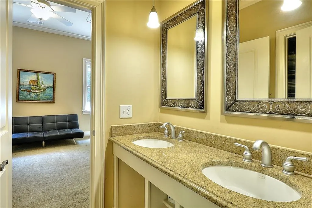 Bathroom with ceiling fan, crown molding, double sink, and oversized vanity