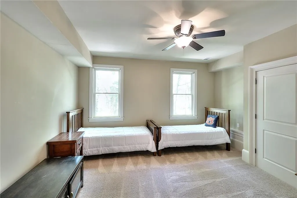 Bedroom featuring light colored carpet and ceiling fan