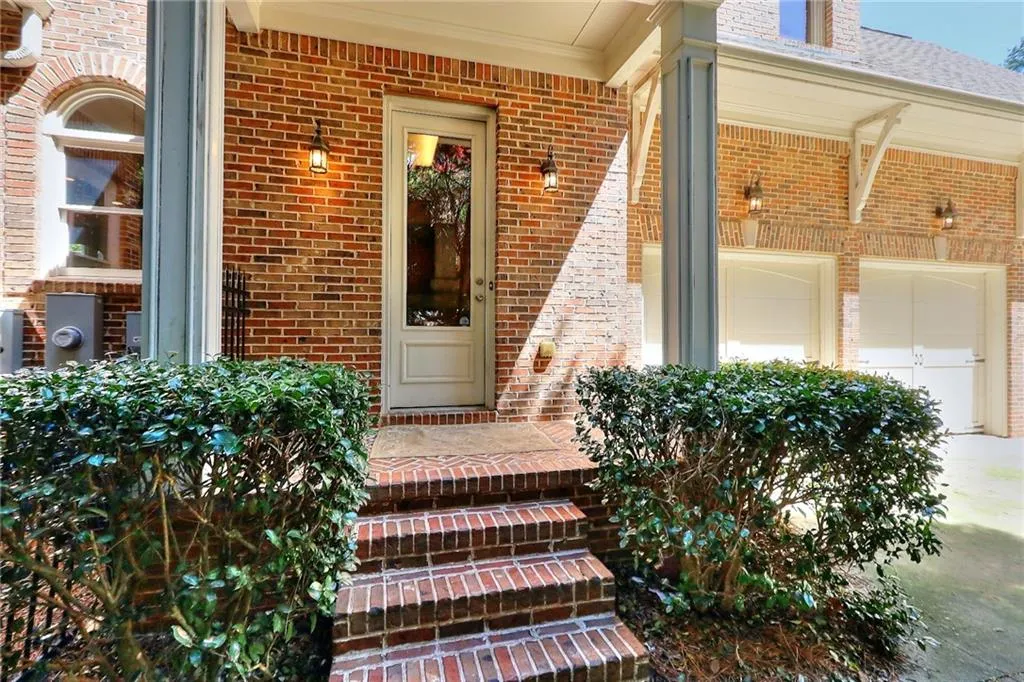 Property entrance with a garage and covered porch