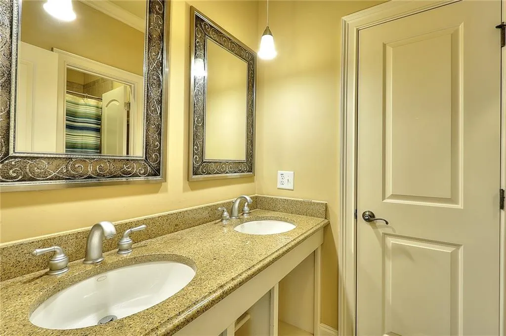 Bathroom featuring crown molding and double vanity