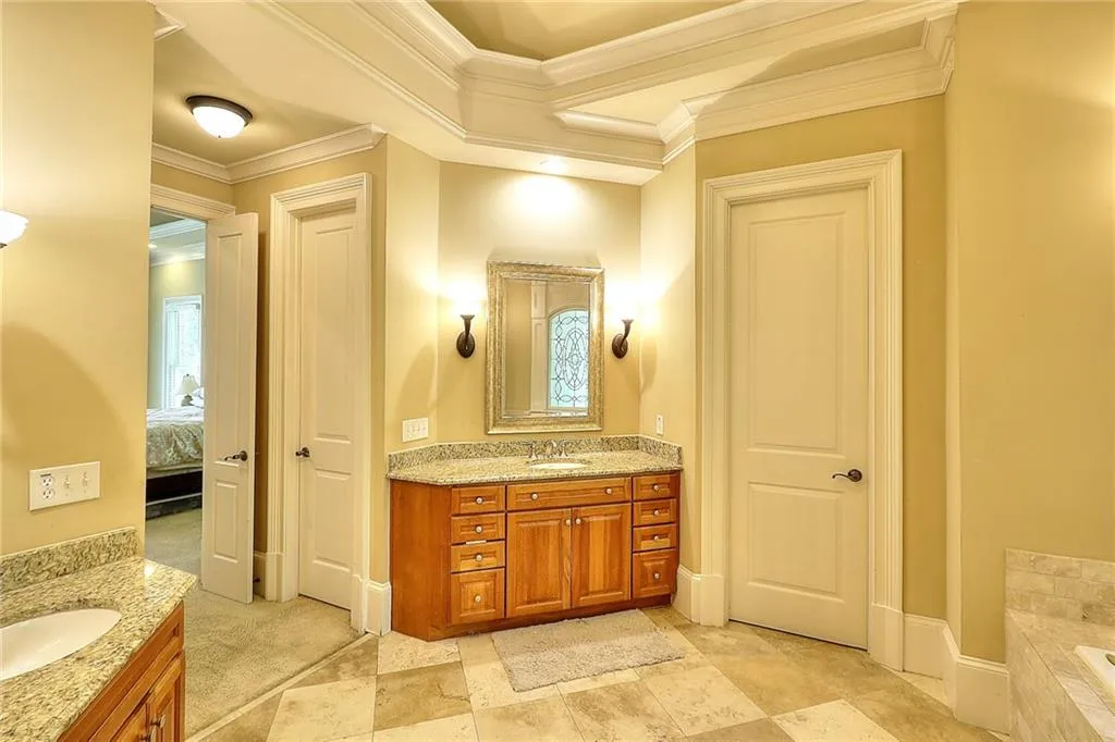 Bathroom featuring vanity, a bath to relax in, tile flooring, and crown molding