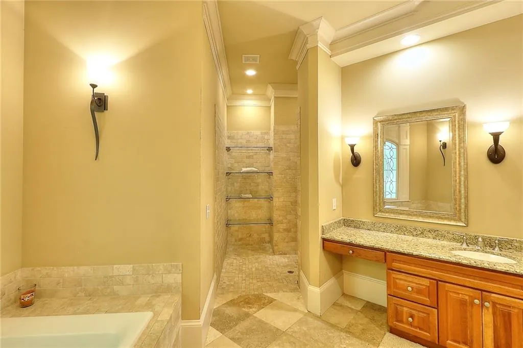 Bathroom featuring vanity, independent shower and bath, tile floors, and crown molding