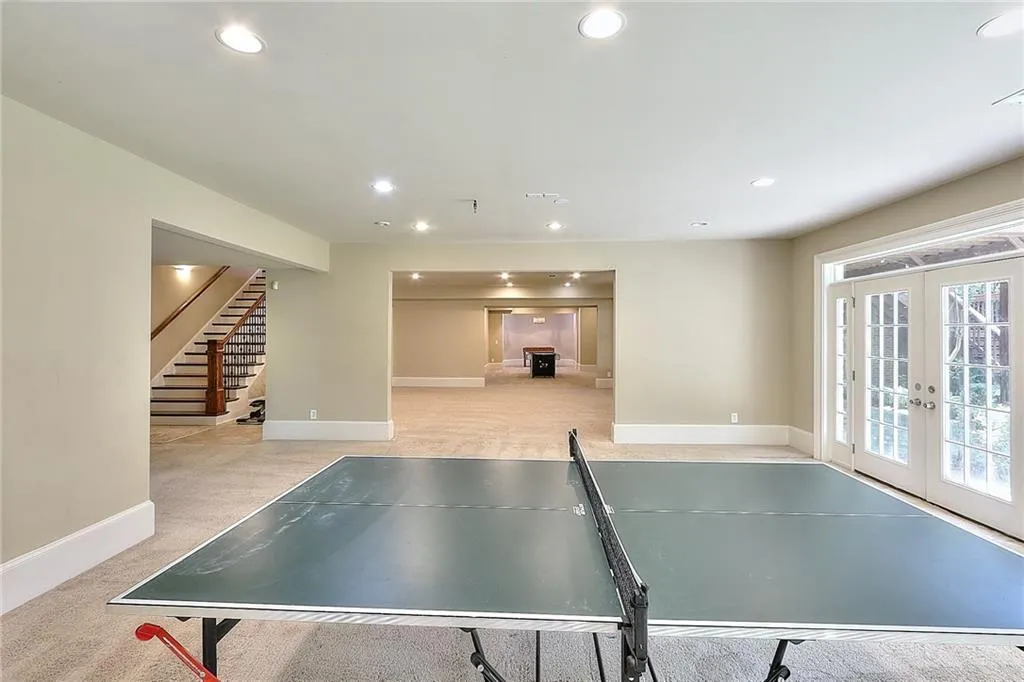 Recreation room with light carpet and french doors
