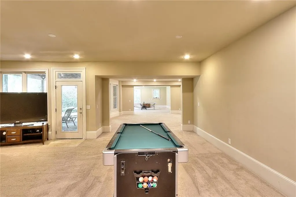 Recreation room with light colored carpet and billiards