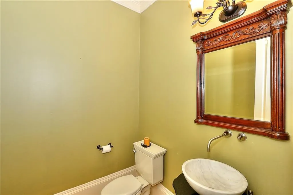 Bathroom featuring ornamental molding and toilet