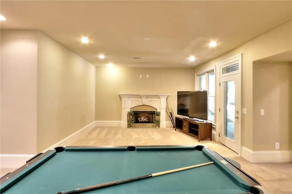 Recreation room featuring light colored carpet and pool table