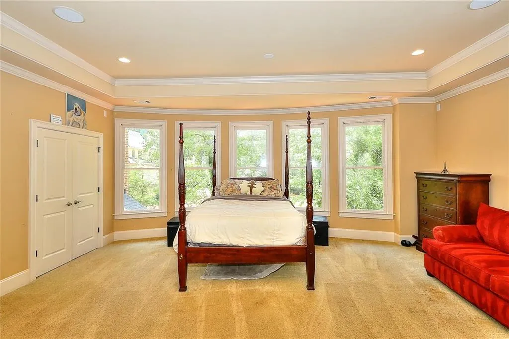 Carpeted bedroom with crown molding