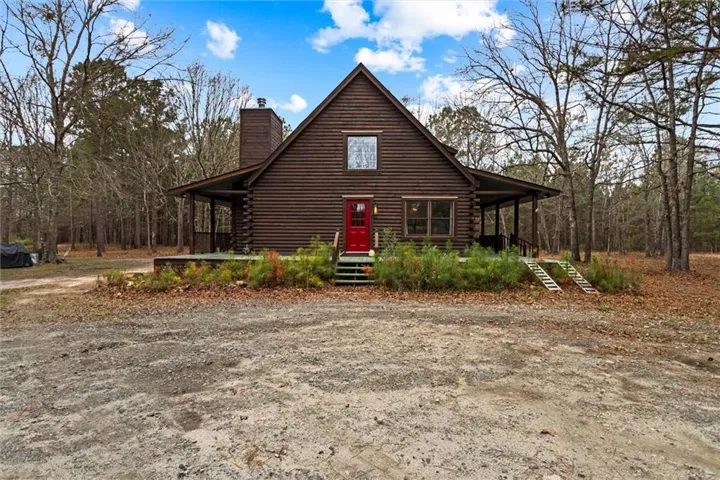 Cabin with log siding and covered porch