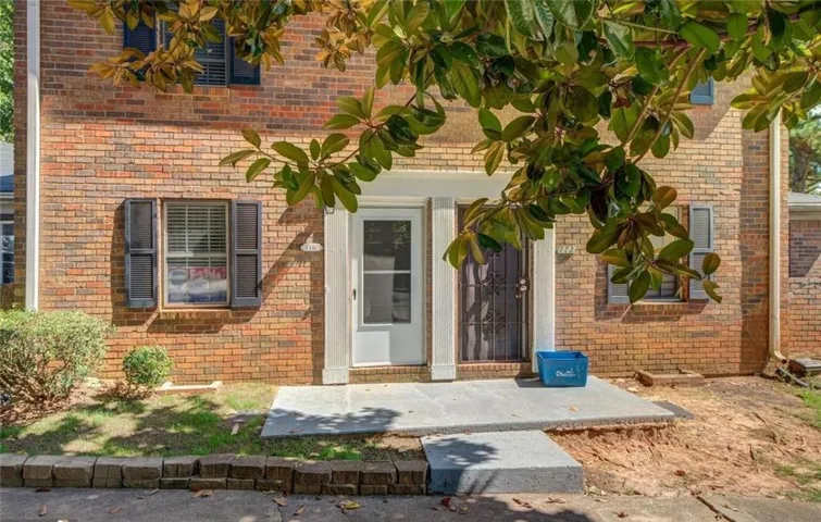 View of exterior entry with brick siding