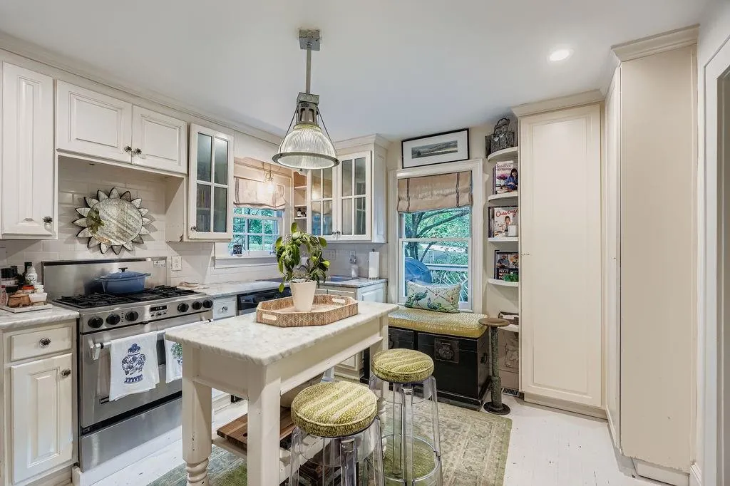 Kitchen with stainless steel gas range oven, healthy amount of natural light, hanging light fixtures, decorative backsplash, and recessed lighting