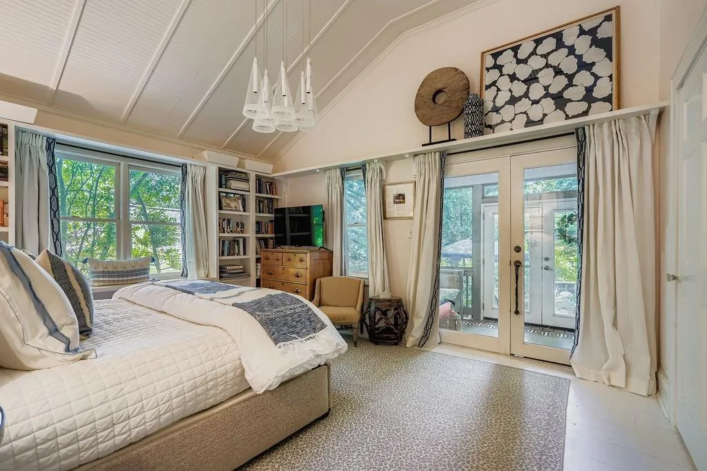 Bedroom featuring french doors, access to exterior, a chandelier, and high vaulted ceiling