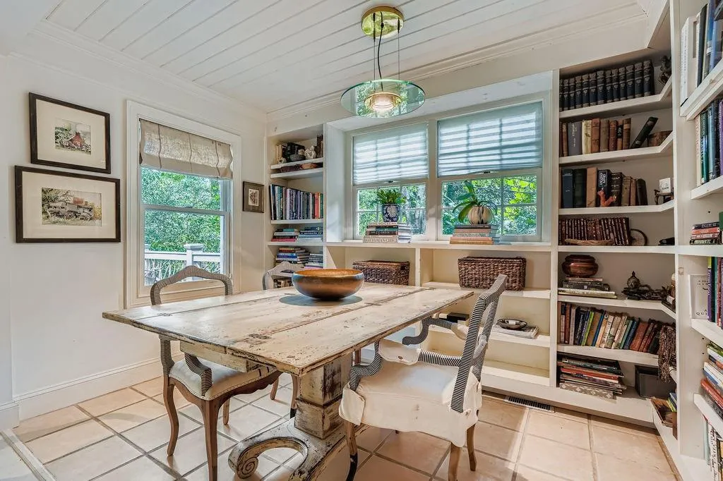 Tiled dining room featuring ornamental molding, built in shelves, and wooden ceiling