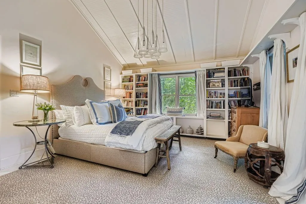 Bedroom featuring carpet, vaulted ceiling, and a chandelier