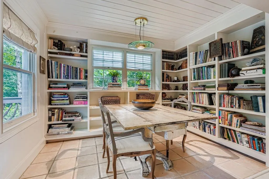 Tiled dining area with crown molding and built in shelves