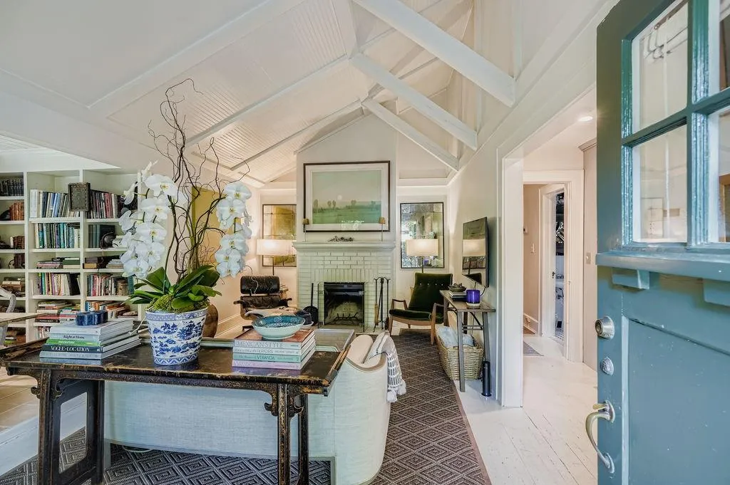 Living area featuring a brick fireplace and wood finished floors