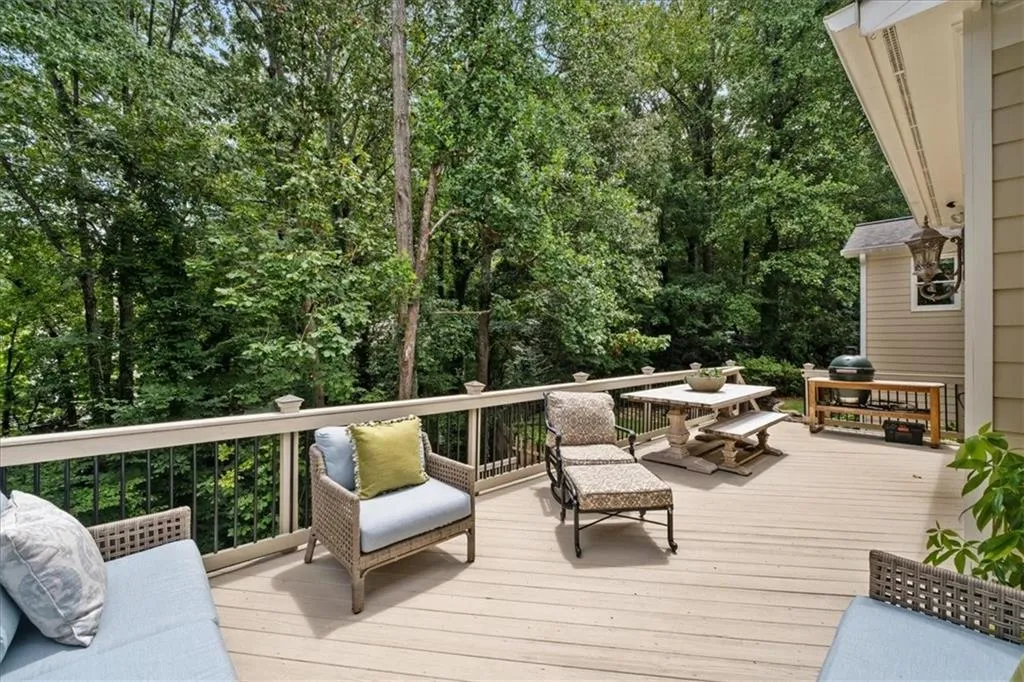 Deck off family room overlooks private, wooded yard.