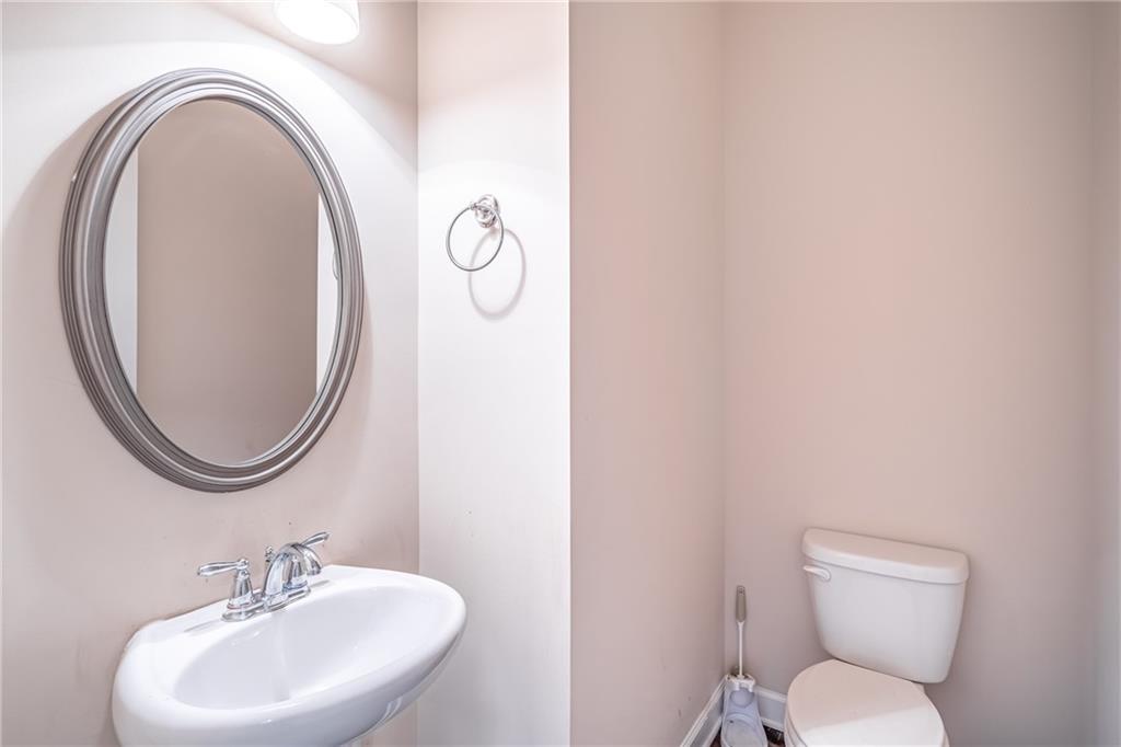 Bathroom featuring toilet and sink Bathroom featuring toilet and sink