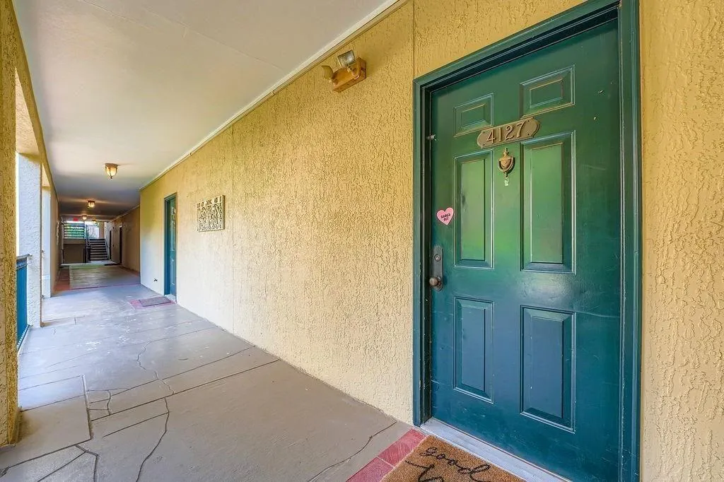 Doorway to property with stucco siding