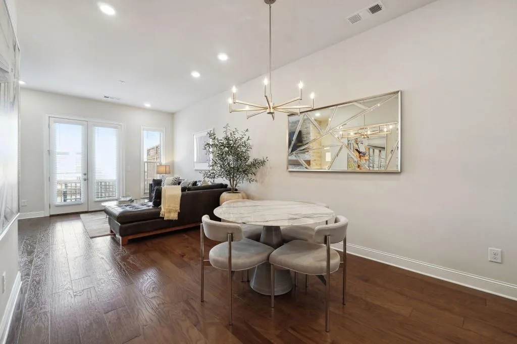 Dining space with an inviting chandelier and dark hardwood / wood-style floors