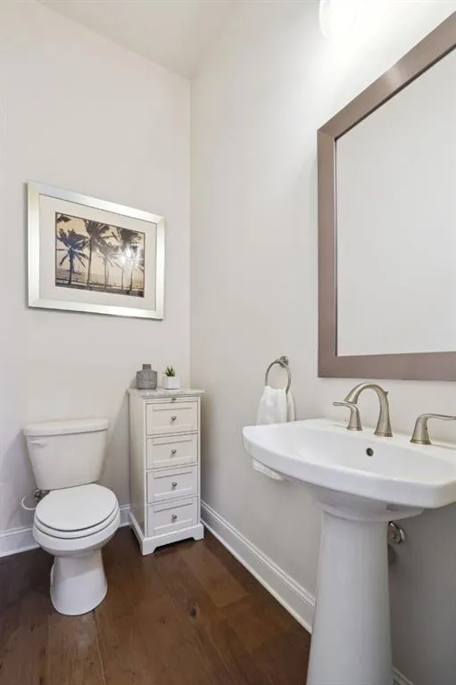 Bathroom featuring hardwood / wood-style flooring and toilet
