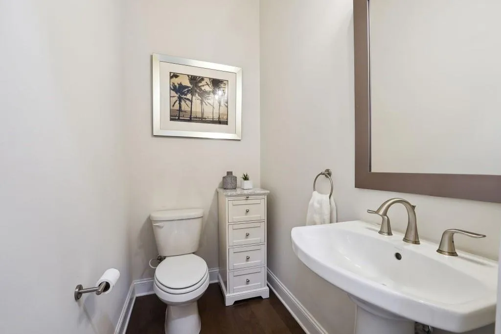 Bathroom with sink, toilet, and hardwood / wood-style flooring